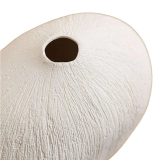 Minimalist white ceramic vase with pebble-inspired shape and textured surface. A sculptural decorative accessory for Japandi, modern, or contemporary interiors.