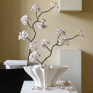 Modern white ceramic vase with spring blossoms.