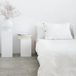 White linen duvet cover and pillows in a minimalist scandi bedroom.
