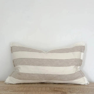 Striped linen cushion with frayed edges and stonewashed texture for relaxed, organic interiors.
