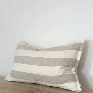 Natural flax and white stripe linen lumbar cushion with frayed edges and stonewashed texture.