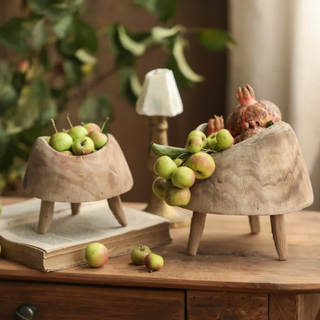 Handcrafted small high-foot display pieces made from Paulownia wood, showcasing a rustic design that highlights the natural beauty of wood and organic aesthetics. These decorative and practical accessories add texture and character to any setting, perfect for displaying fruit, plants, trinkets, potpourri, or holiday ornaments. Ideal for natural home décor.