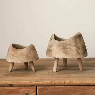 Handcrafted tripod wooden display stands made from natural Paulownia wood with a rustic, organic finish and styled on top f a sideboard.