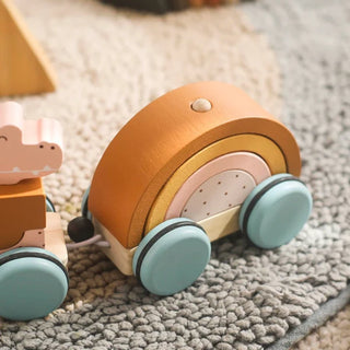 Wooden Montessori zoo train toy with detachable animal carriages in soft natural tones, perfect for toddler pull-along play.