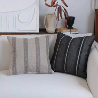 Kaya linen blend cushion covers in black stripe and natural on a white sofa