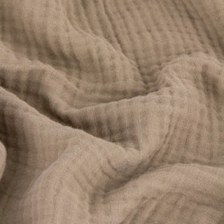 Close up of the crinkled four layer muslin texture on the Nori latte throw
