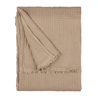 Nori latte cotton muslin throw folded, showing the crinkled texture and fringed edge