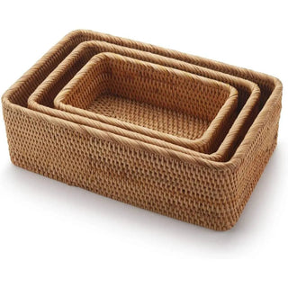 Set of handwoven natural rattan storage baskets in three sizes, ideal for organising or serving snacks in an eco-friendly home.