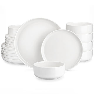 White ceramic dinnerware set with dinner plates, side plates and bowls stacked on white