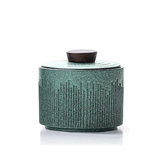 Elegant ceramic tea caddy with a dark walnut lid, perfect for kitchen or home organization. Featuring a textured, artisanal design in a turquoise hue, this airtight container is ideal for storing tea, coffee, spices, or small household items. A stylish and functional kitchen addition to a contemporary, minimalist or Japanese aesthetic.
