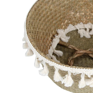 Handwoven natural seagrass storage basket with handles, perfect as a stylish hanging basket, pot planter, or decorative storage solution. This eco-friendly basket, adorned with charming tasselled fringe, adds a natural boho touch while keeping your space organized. Shop handcrafted storage baskets at our natural homeware store.